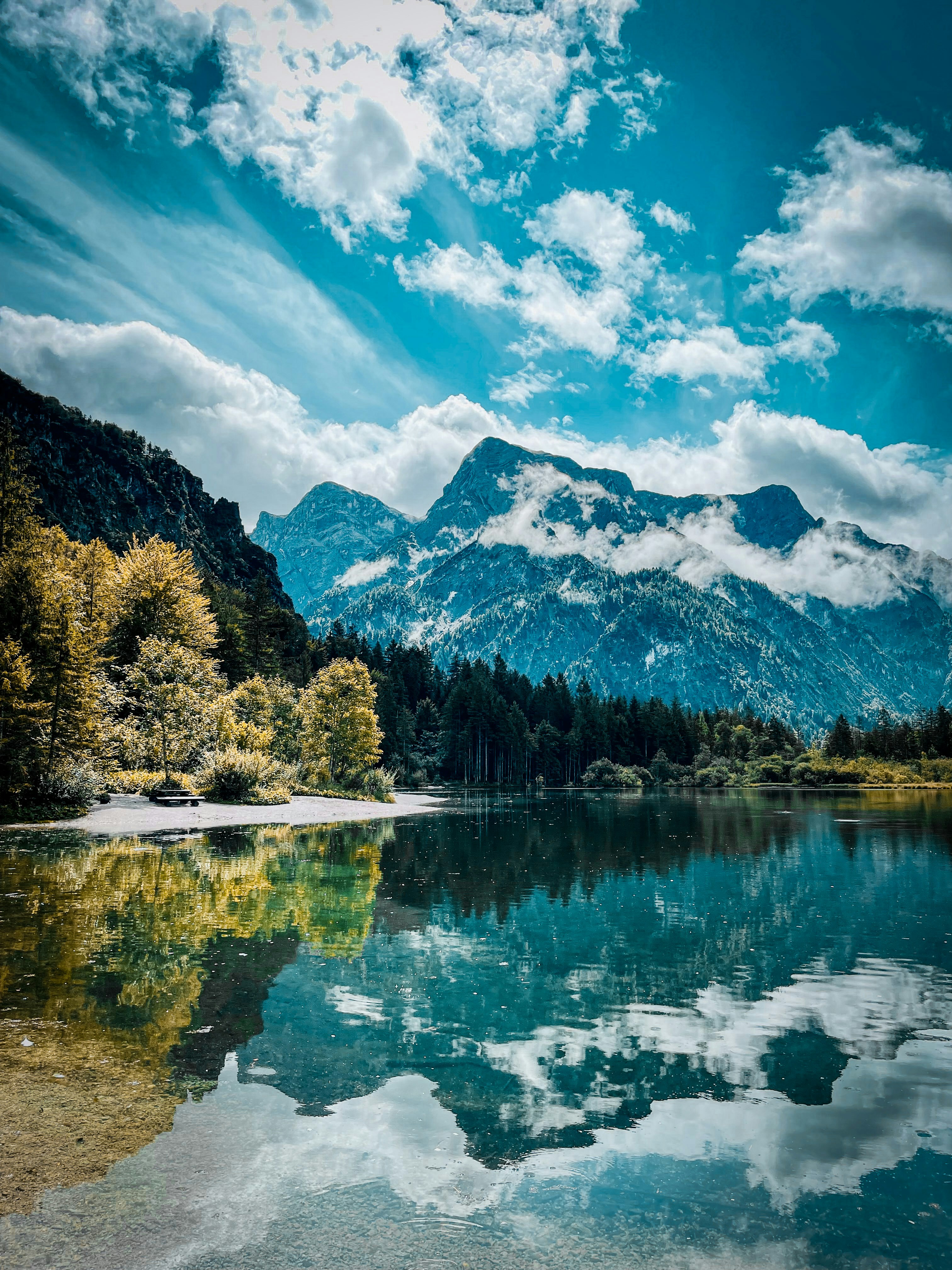 Majestic mountain lake surrounded by towering peaks and lush forests